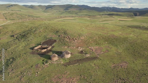 Rural Basotho homestead atop vast grassy hilltop in Lesotho, seen from above