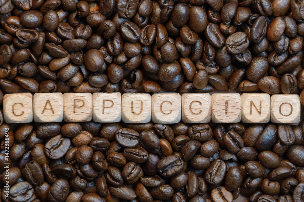Fototapeta premium Cappuccino letters on coffee bean background: rustic wooden block art