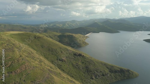 Aerial rise to reveal Mohale Dam wall and distant green mountains in Lesotho 
