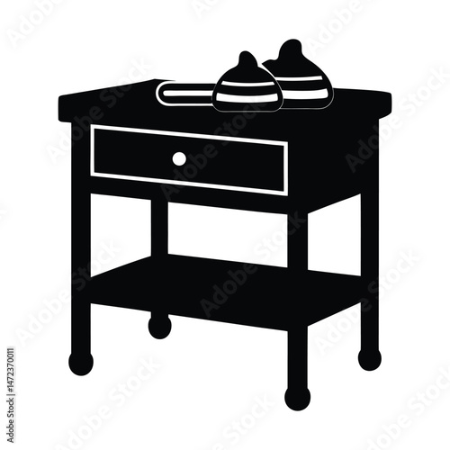 vector silhouette of a silhouette of a changing table with a stack on white background