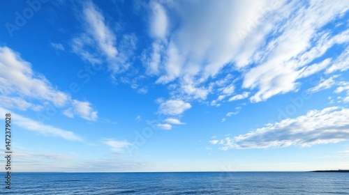Serene seascape showcasing a vast expanse of blue ocean under a vibrant sky filled with fluffy white cumulus clouds. : Generative AI