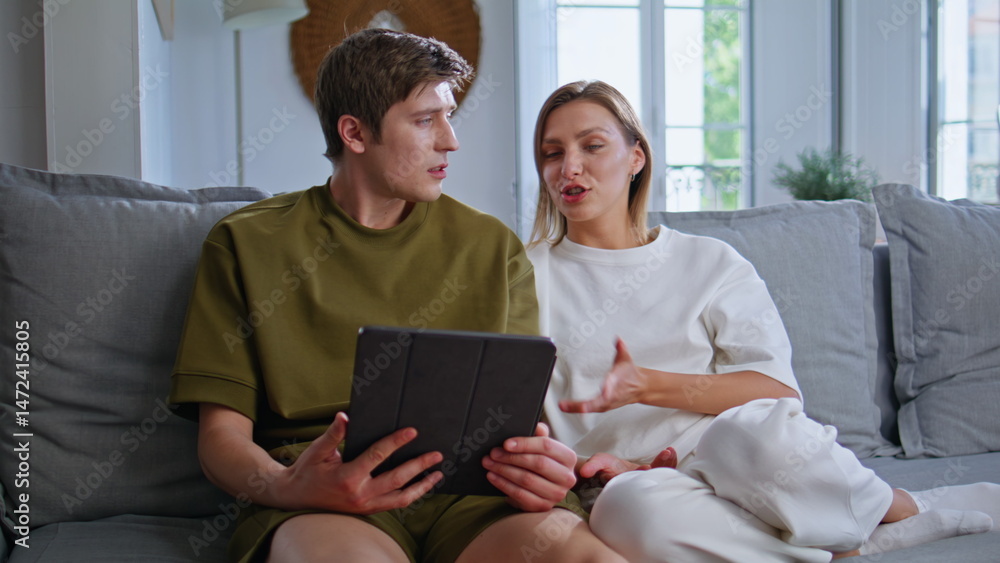 Teenagers talking online meeting by tablet at home couch closeup. Couple calling