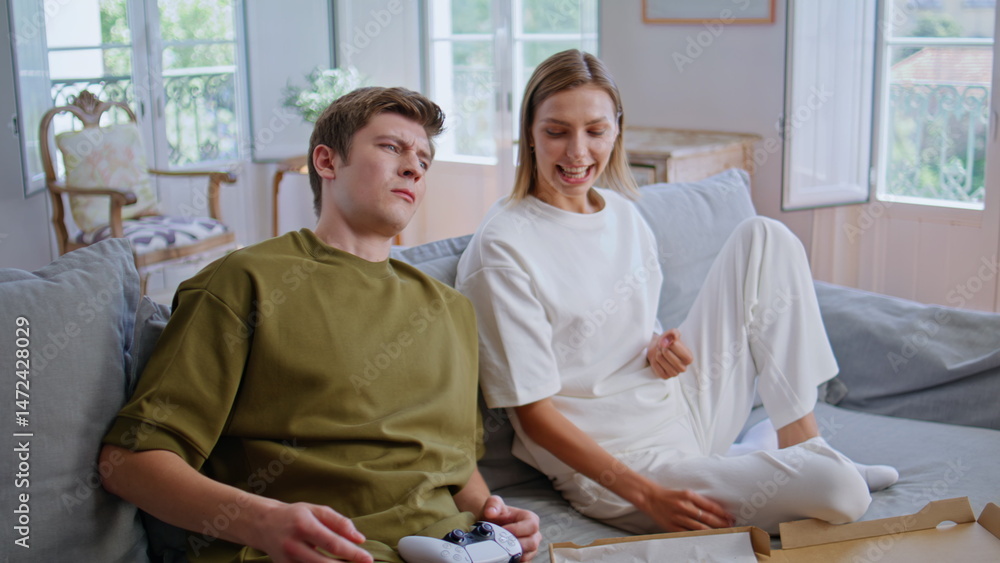 Video players sitting sofa man holding console at home closeup. Competing online
