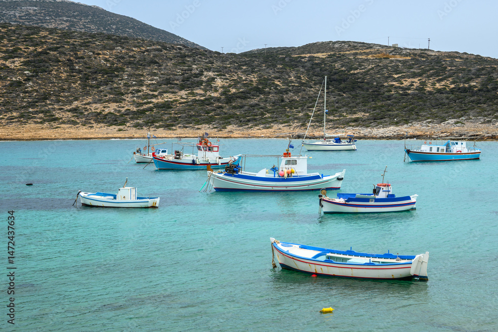 Boats moored in the bay of Kalotaritissa Beach. Amorgos, Cyclades, Greece Boats moored in the bay of Kalotaritissa Beach. Amorgos, Cyclades, Greece