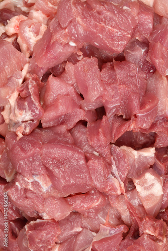 Obraz na płótnie A close-up shows a pile of raw, diced pork meat, ready for cooking w salonie