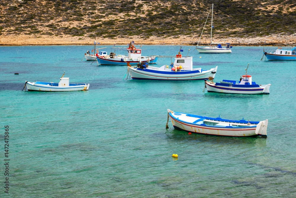 Boats moored in the bay of Kalotaritissa Beach. Amorgos, Cyclades, Greece Boats moored in the bay of Kalotaritissa Beach. Amorgos, Cyclades, Greece