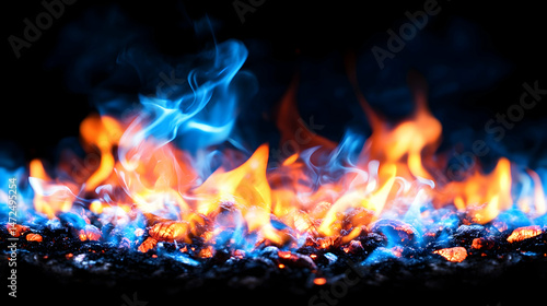 Vibrant blue and orange flames dance atop glowing embers against a stark black background