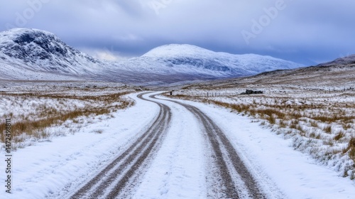 Wallpaper Mural A winding snow-covered road leads towards majestic, snow-capped mountains under a dramatic, cloudy sky in a remote, wintry landscape. : Generative AI Torontodigital.ca