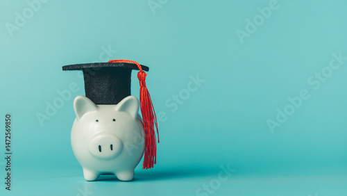 Piggy bank wearing graduati...