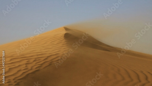 Sand blowing over sand dunes in wind