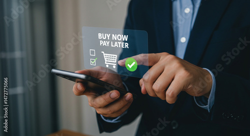 A person using a smartphone with a buy now pay later option displayed on the screen in front of them