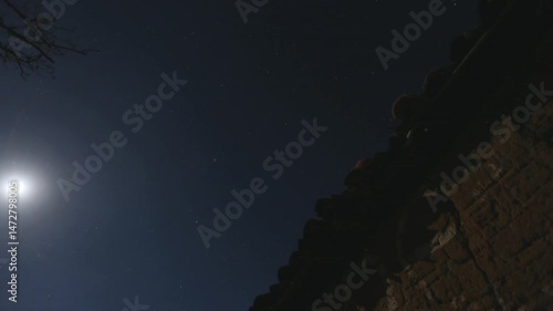 Timelapse of starry night sky with moon