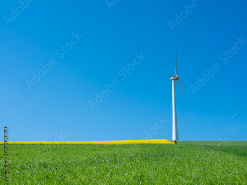 Obraz na płótnie countryside landscape in luxemburg with wind turbine under blue sky in spring w salonie