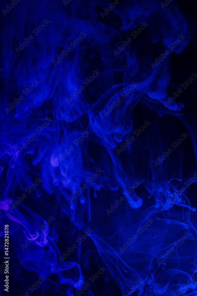 Vertical composition of flowing blue smoke patterns.