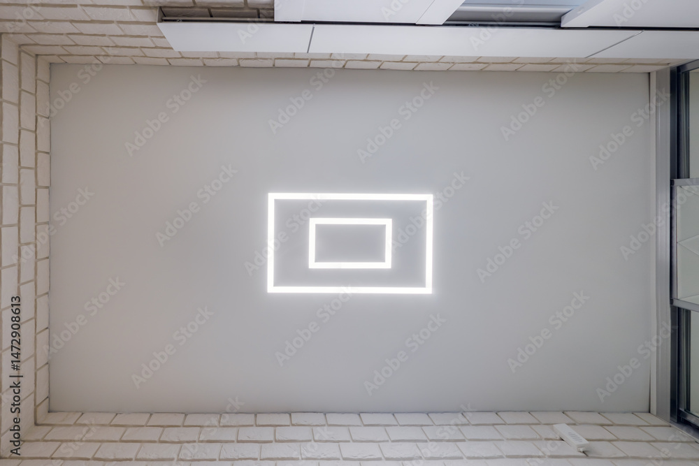Fototapeta premium suspended ceiling with halogen spots lamps in form of squares and rectangles and drywall construction in empty room in apartment or house. Stretch ceiling white and complex shape.