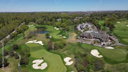 Aerial view of golf course on a sunny summer day with beautiful forest view