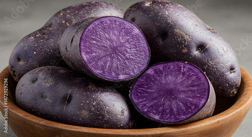 Vibrant Purple Majesty Potatoes Displayed In Rustic Wooden Bowl On Neutral Backdrop