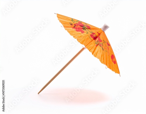 Tiny orange parasol with floral details, stick, and shadow on a white background