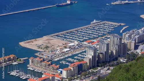 Aerial view of Ocean Village Marina, showcasing luxury yachts, residential buildings, and the bustling harbor of Gibraltar