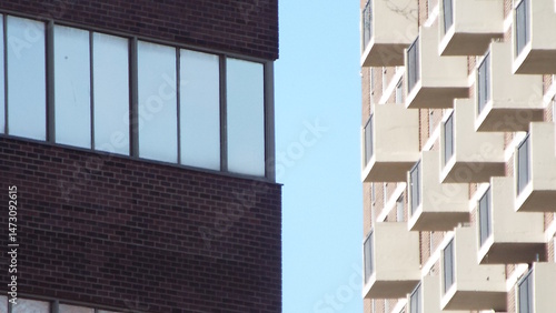 Fotografie A close view of two contrasting buildings under a clear blue sky