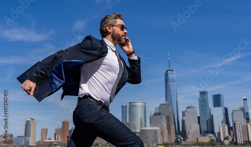 Business success in big city. Businessman running to success. Business success. Successful businessman hurrying on New York city skyline. Business man in Manhattan. Running to meet a deadline