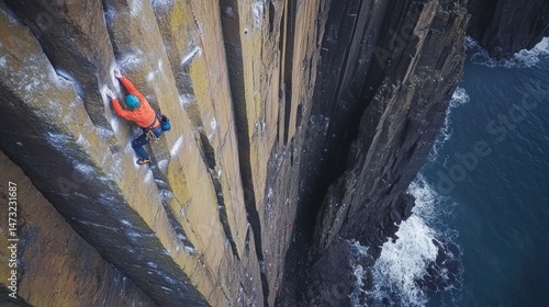 Climber ascends sheer rock face