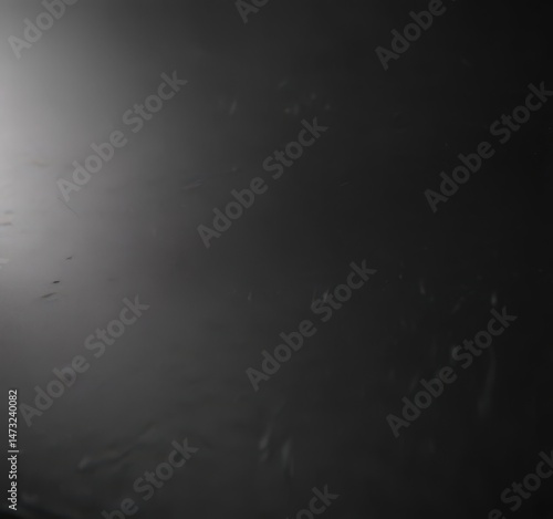 Deep black polished aluminum surface reflects light, showing subtle texture , industrial, texture