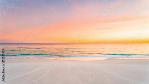 Serene beach at sunset with soft pastel hues of pink, orange, and yellow reflecting on calm sea and smooth sandy shore