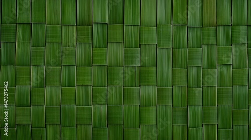 Woven green palm leaves create a natural, textured pattern in a traditional, eco-friendly style.