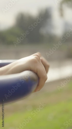 close-up shots of latina woman using fitness machine outdoors