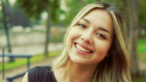 smiling latina woman after exercising in public park