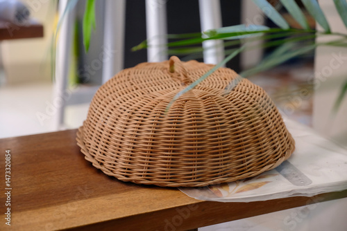 traditional Asian food cover made of rattan on wooden bench