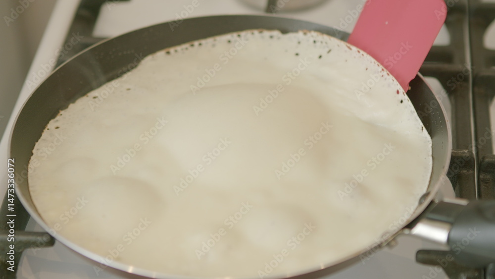 Fototapeta premium Bubbling Milk in a Pan on the Stove is an essential and delightful culinary activity