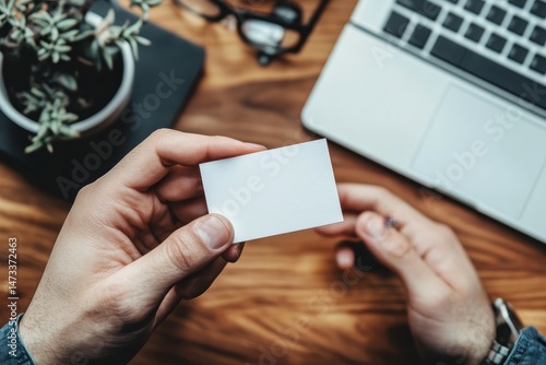 flawless image of man holding his business card and calling the contact number on it
