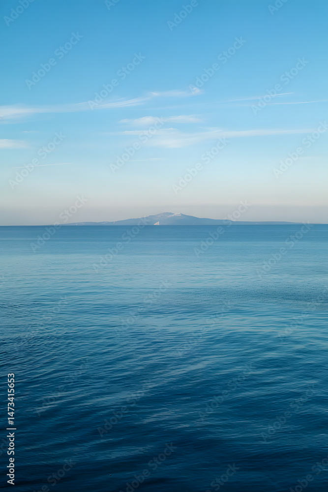 Obraz premium Serene Ocean View with Distant Mountain