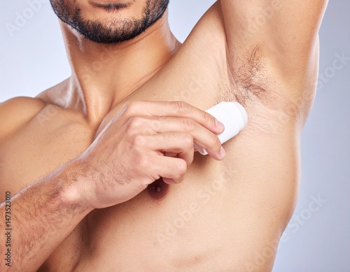 Man applying deodorant to armpit. Hygiene routine for cleanliness and freshness