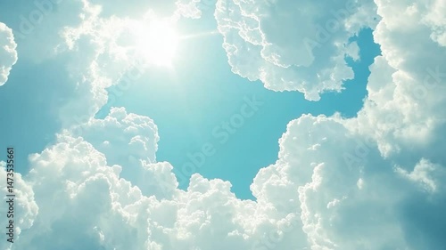 Bright sun shining through a gap in fluffy white clouds against a light blue sky