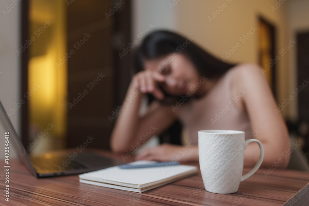 Tired freelancer woman taking a break at home office desk Tired freelancer woman taking a break at home office desk