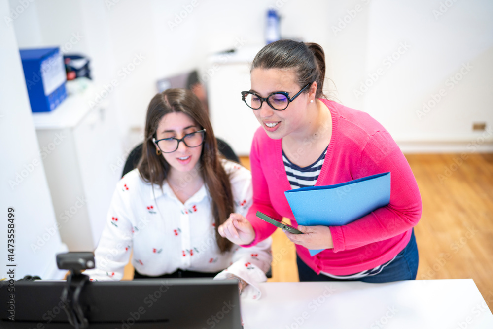 Two Young Women Collaborating on a Computer call Two Young Women Collaborating on a Computer call