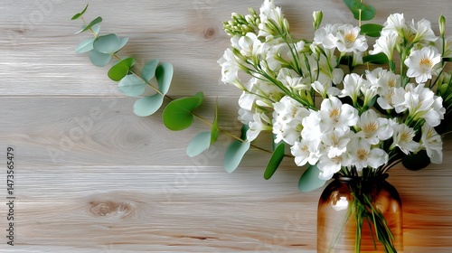 Elegant Arrangement of White Flowers in a Glass Vase on a Wooden Surface