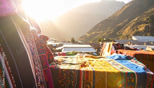 Colorful textiles overlaying rooftops, with sunlit mountains in background