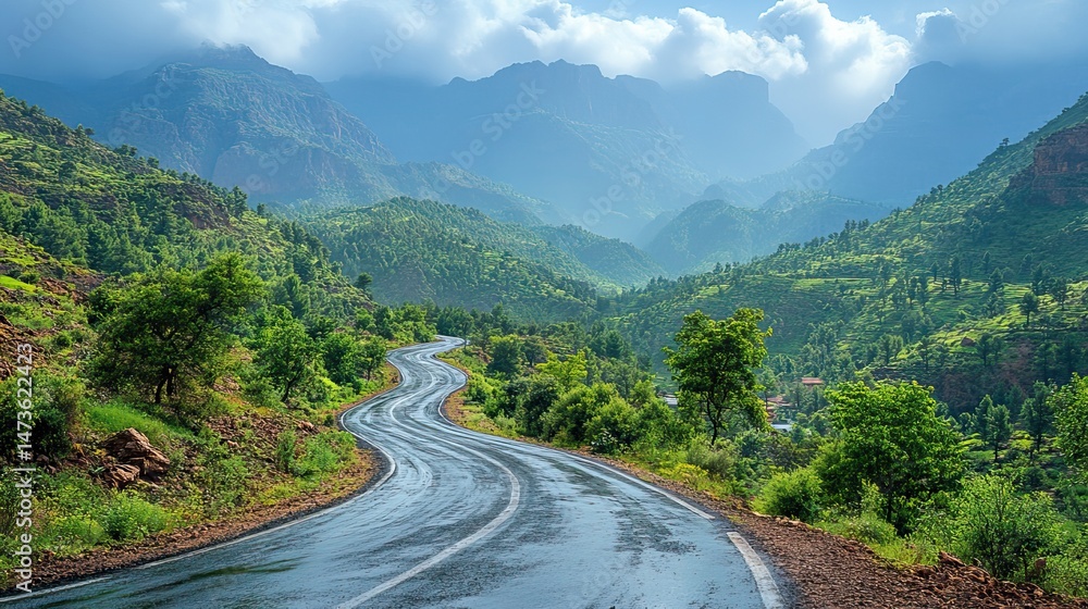 Fototapeta premium A winding mountain road snakes through a scenic landscape, offering breathtaking views at every turn and promising adventure for those who travel its path