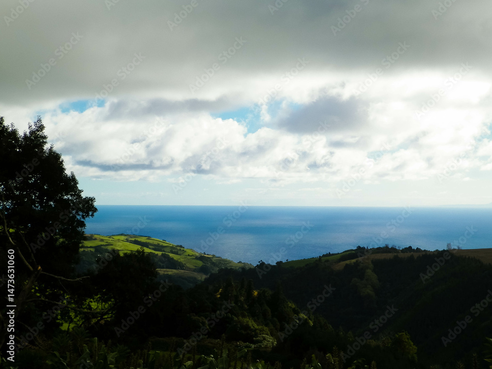 Typical landscape of Azores. Natural green fields hills and sea.