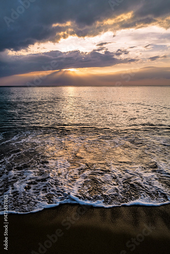 Sunset on the beach with waves.