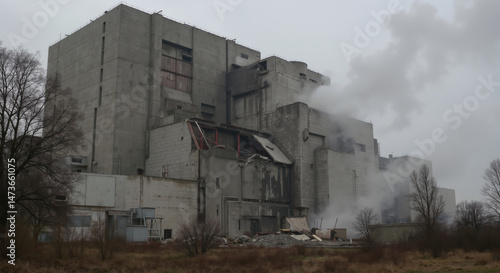 Damaged industrial concrete building with collapsed walls and smoke. Abandoned facility after disaster for urban exploration, post-apocalyptic imagery and industrial risk documentation