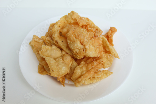 Kerupuk pangsit, or crispy fried skin dumpling, isolated in white background