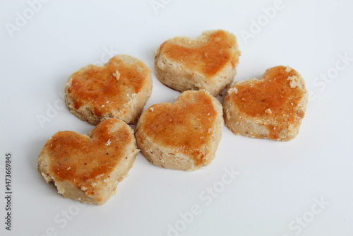 Peanut cookies in love shape, isolated on white background