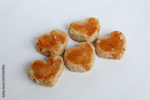 Peanut cookies in love shape, isolated on white background