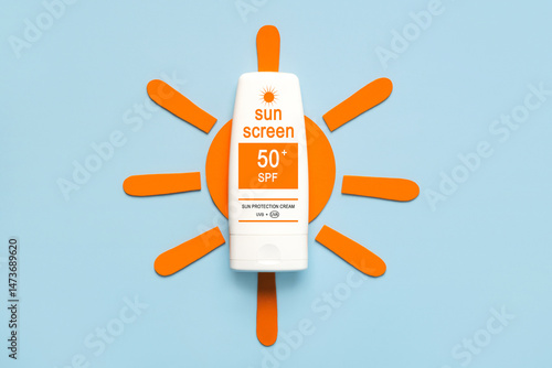 Top view of bottle of sunscreen on an orange sun. Concept of sun protection