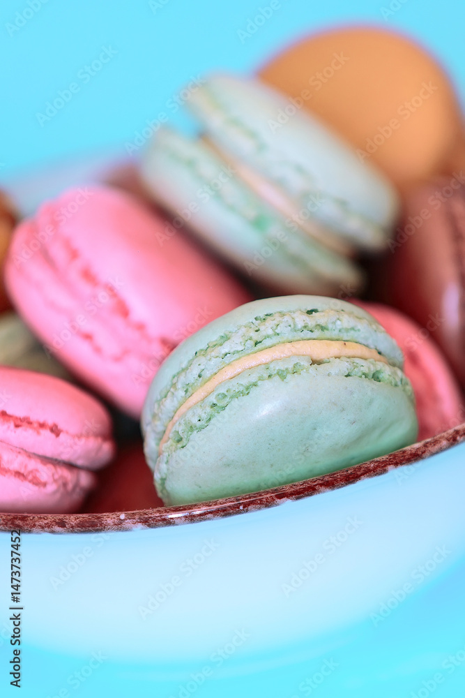 Cake macaron or macaroon on turquoise background